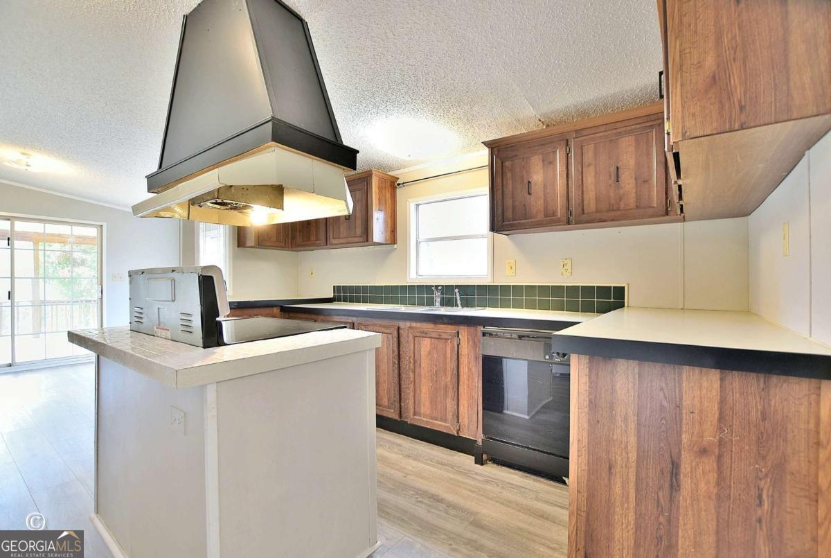 760 Hamilton Mulberry Grove Road Cataula, GA 31804 - Photo 5 of 26 a kitchen with stainless steel appliances a sink and a stove