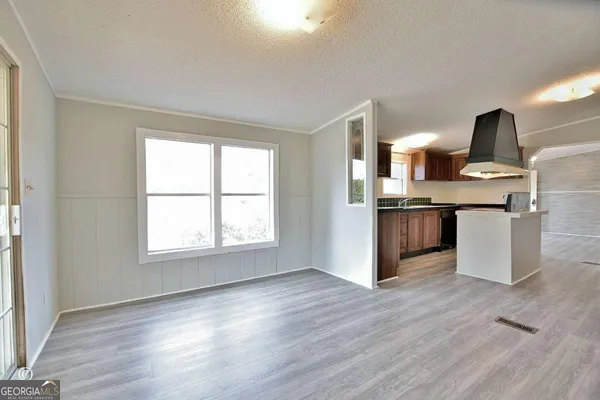 a kitchen with stainless steel appliances granite countertop a sink and a wooden floors