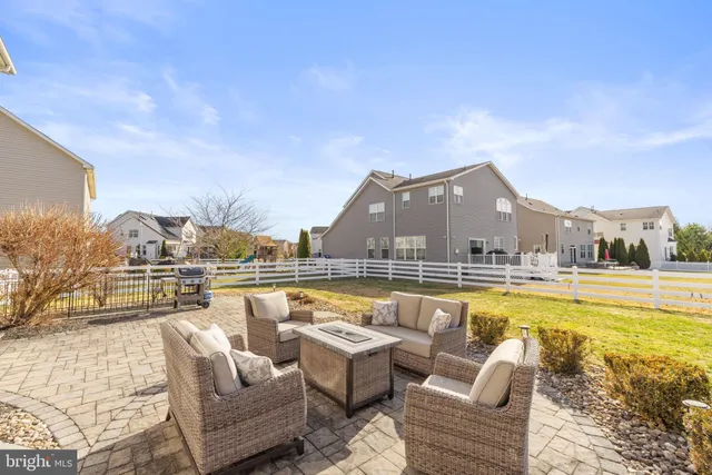 a view of swimming pool with couch and chairs