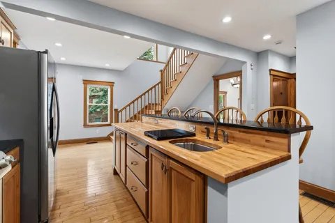 a kitchen that has a sink a stove and a refrigerator