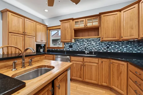 a kitchen with stainless steel appliances a sink and cabinets