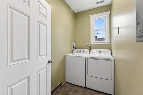 a living room with furniture a flat screen tv and kitchen view