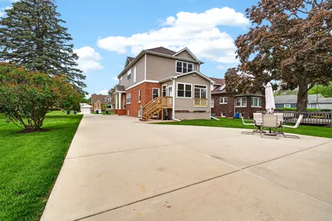 a front view of house with yard and green space