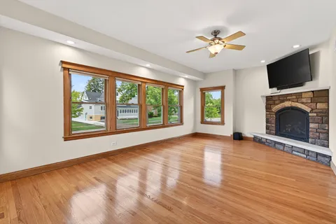 a view of an empty room with a window and kitchen view