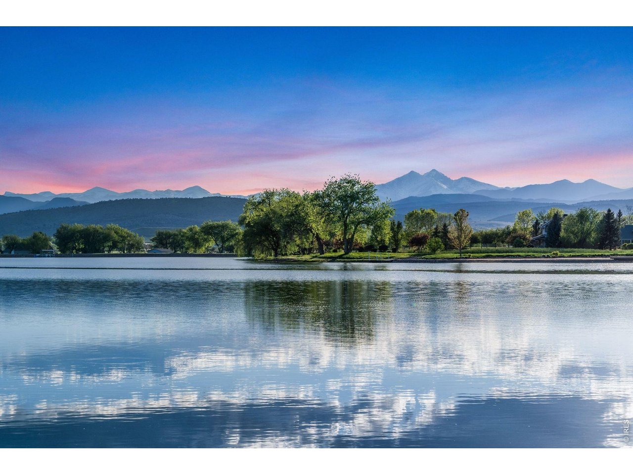 9715 Meadow Ridge Lane Longmont, CO 80504 - Photo 15 of 17 a view of a lake with a mountain