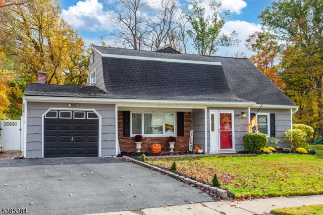 a front view of house with yard and outdoor seating