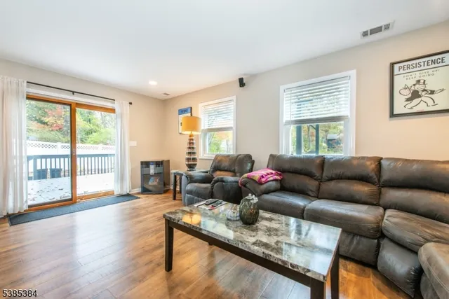 a kitchen with granite countertop white cabinets a sink a window and stainless steel appliances