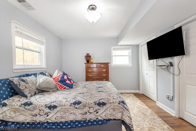 a bathroom with a granite countertop sink a mirror and a shower