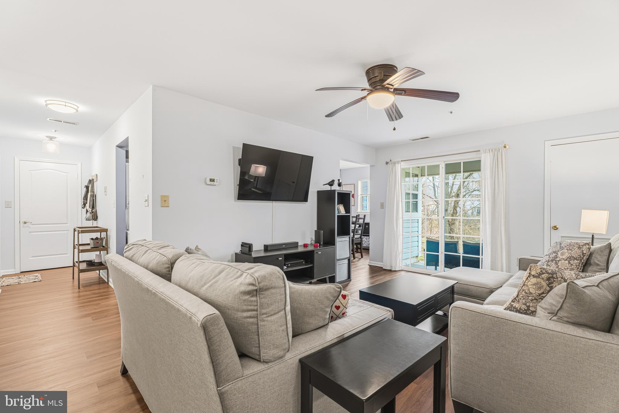 8495 Falls Run Road, Unit B Ellicott City, MD 21043 - Photo 11 of 34 a living room with furniture a ceiling fan and a flat screen tv