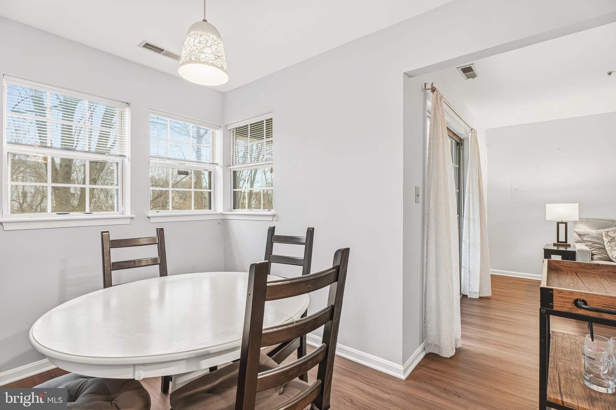 8495 Falls Run Road, Unit B Ellicott City, MD 21043 - Photo 16 of 34 a view of a dining room with furniture and wooden floor