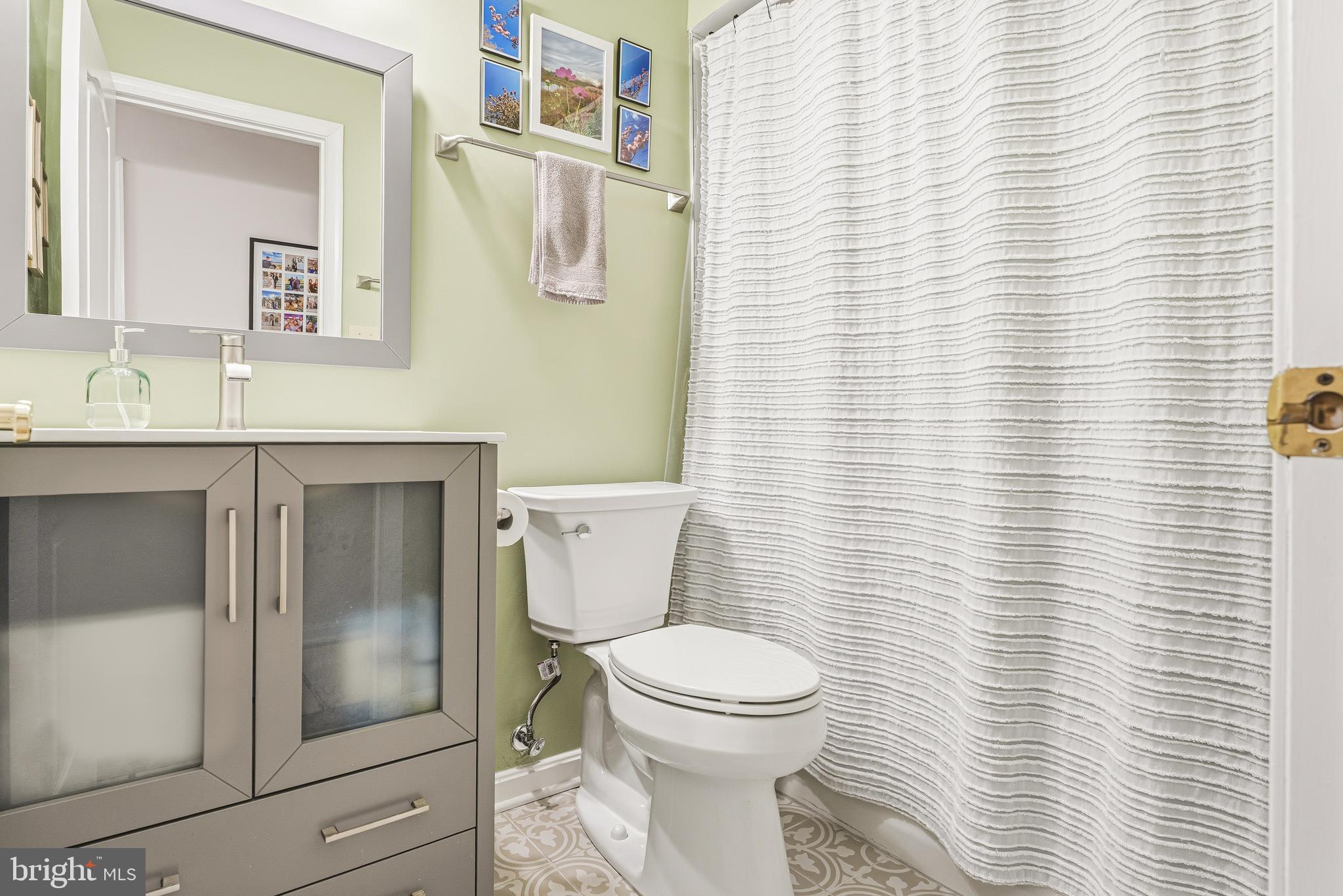8495 Falls Run Road, Unit B Ellicott City, MD 21043 - Photo 28 of 34 a bathroom with a toilet a sink and a mirror