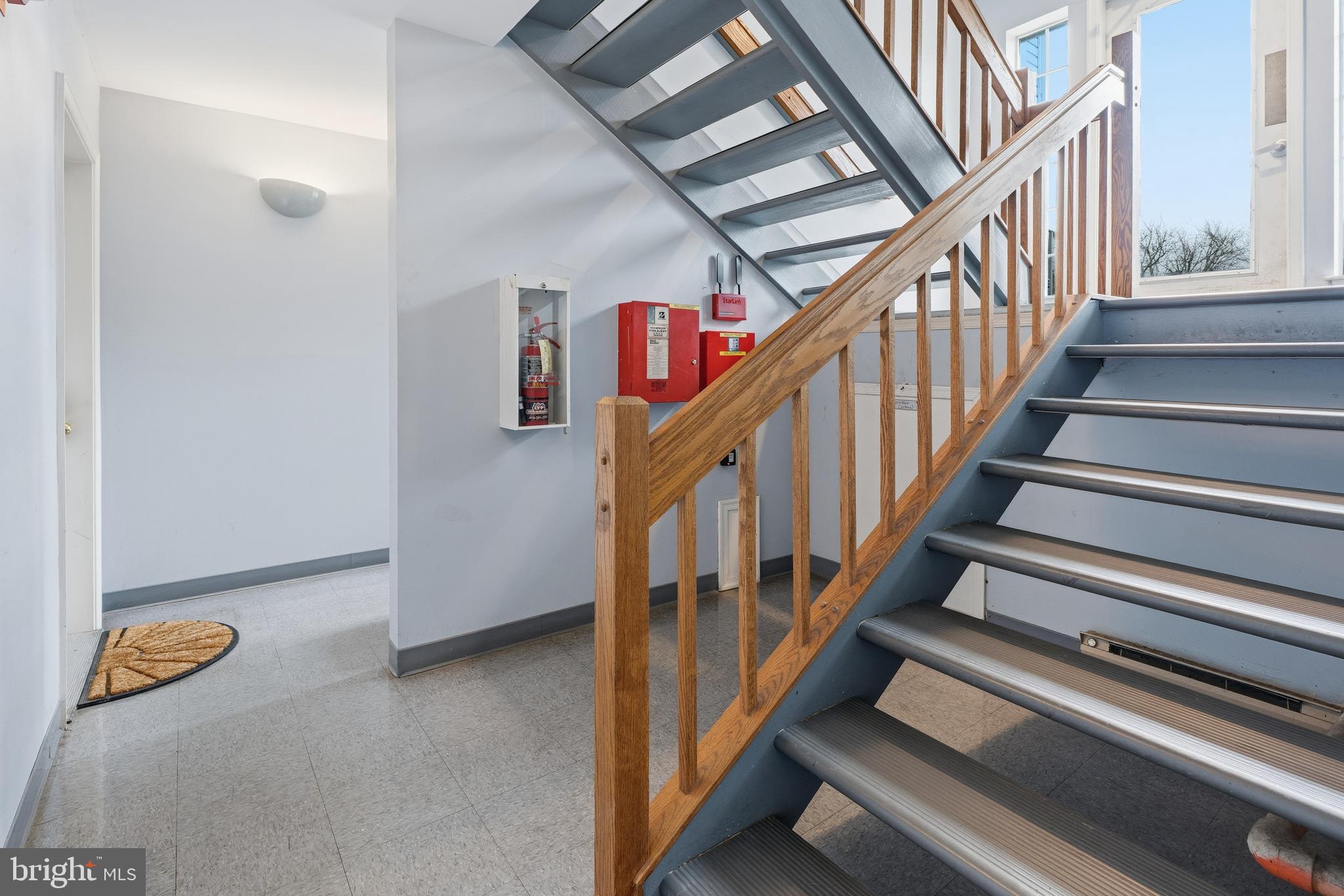 8495 Falls Run Road, Unit B Ellicott City, MD 21043 - Photo 6 of 34 a view of staircase with lots of frames on wall