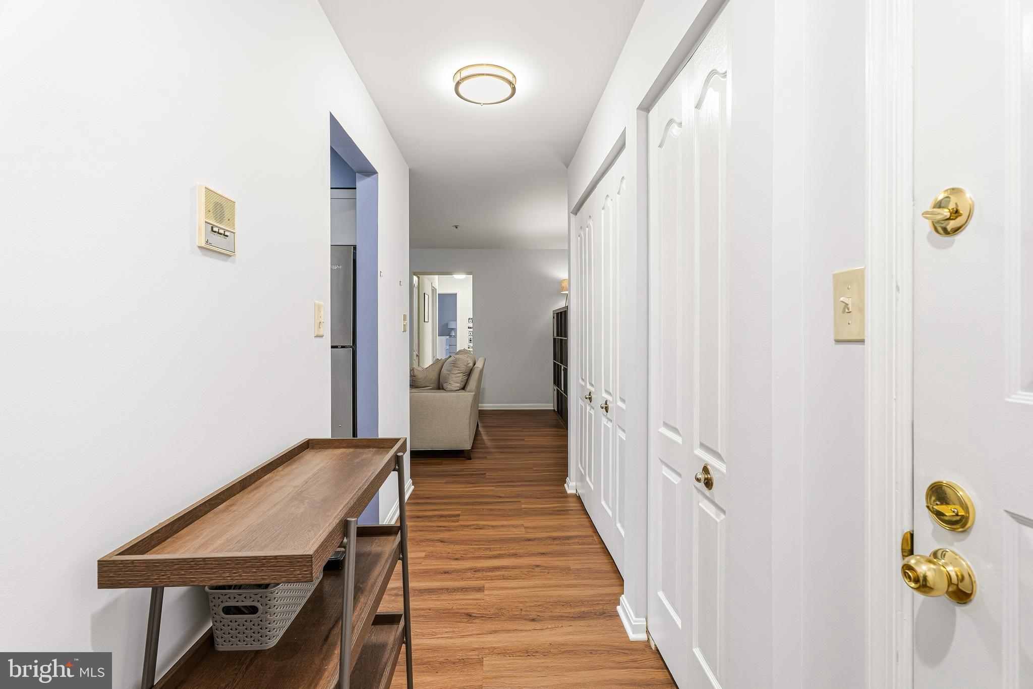 8495 Falls Run Road, Unit B Ellicott City, MD 21043 - Photo 7 of 34 a view of a hallway with wooden floor and furniture