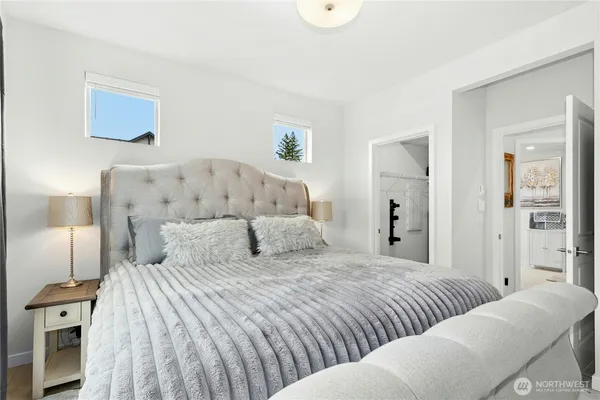 a bedroom with a large bed and a painting on the wall