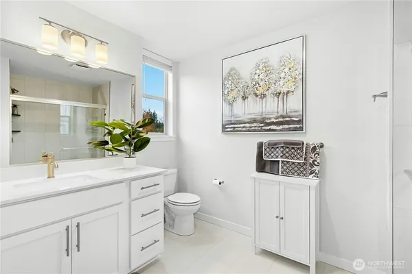 a bathroom with a glass shower door
