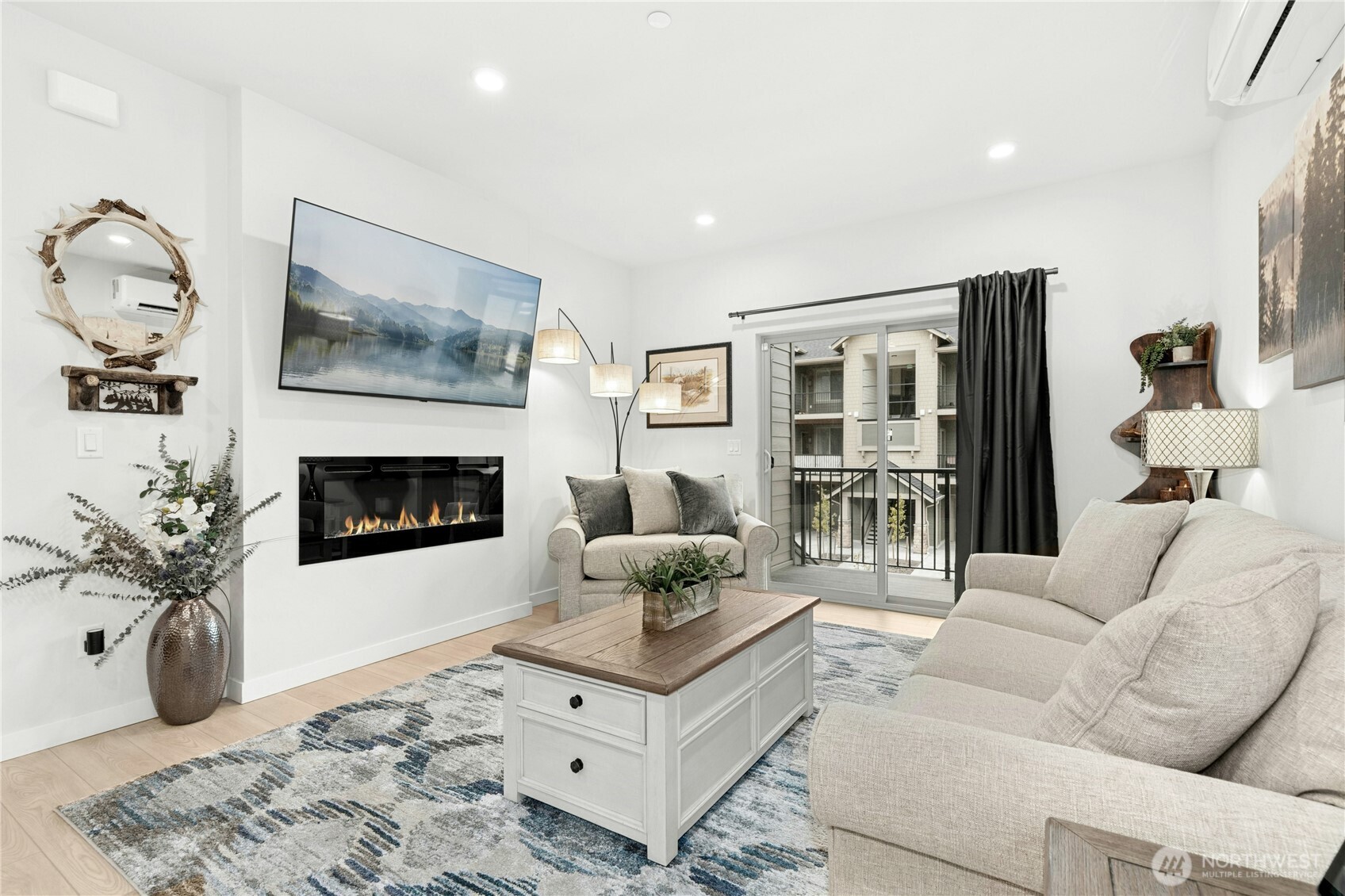 1845 Southeast 12th Place, Unit H204 North Bend, WA 98045 - Photo 3 of 31 a living room with furniture and a fireplace