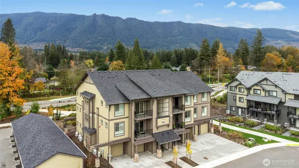 a aerial view of a house with a big yard and large tree