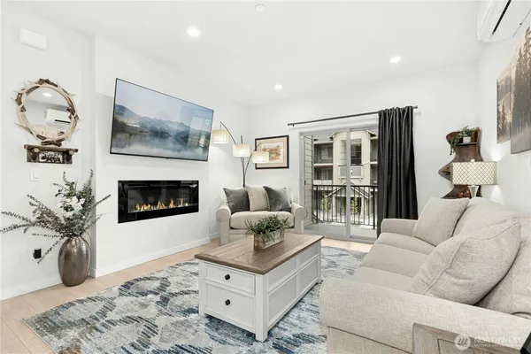 a living room with furniture and a fireplace
