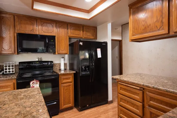 a kitchen with a refrigerator and a stove top oven