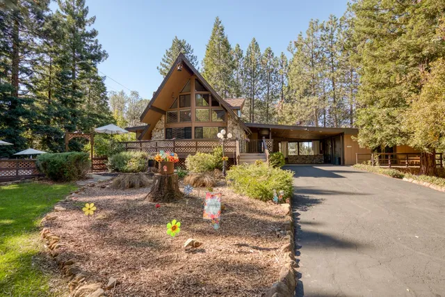 a front view of a house with a yard garage and outdoor seating