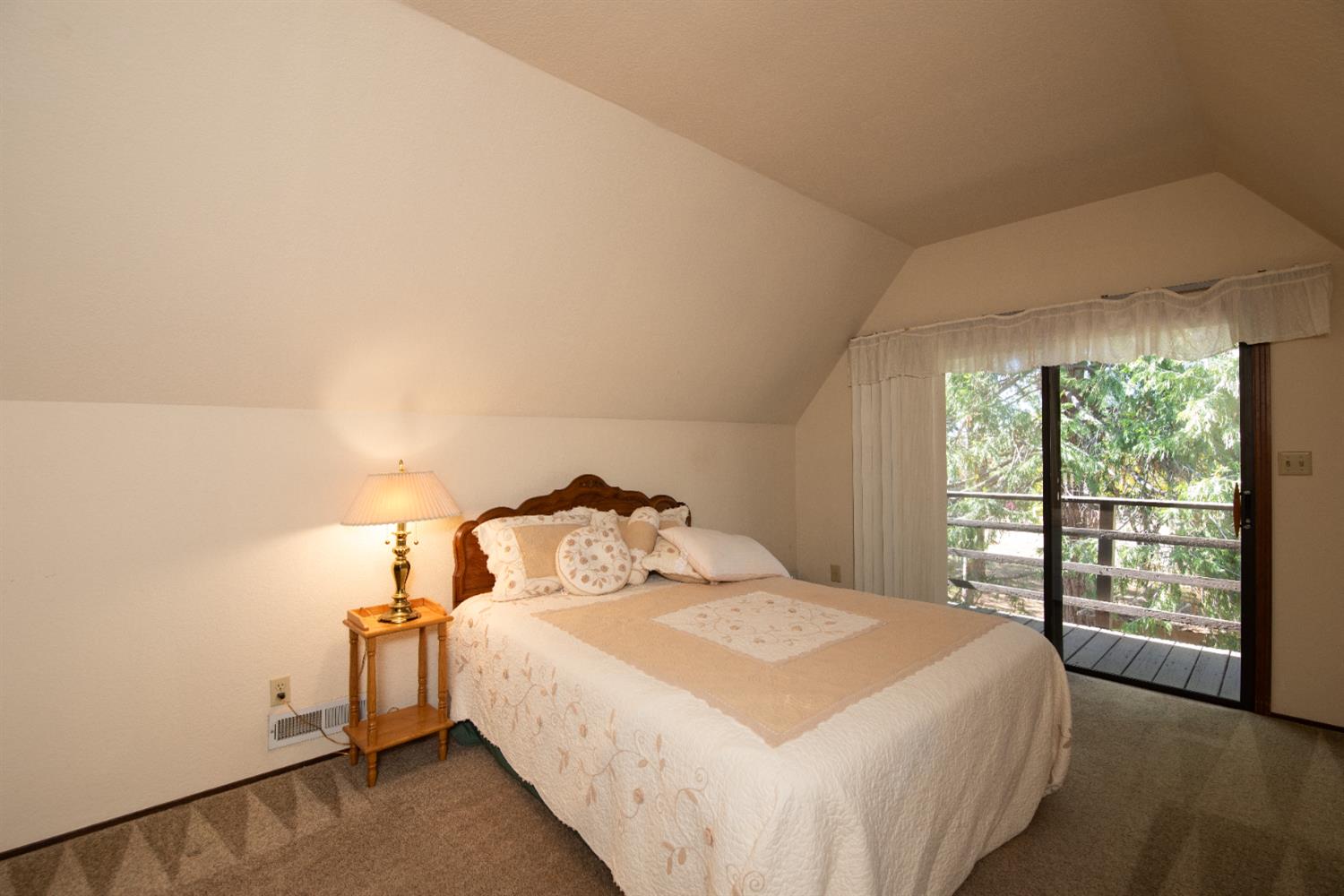 16979 Ridge Road Pine Grove, CA 95665 - Photo 21 of 68 a bedroom with a bed and a large window