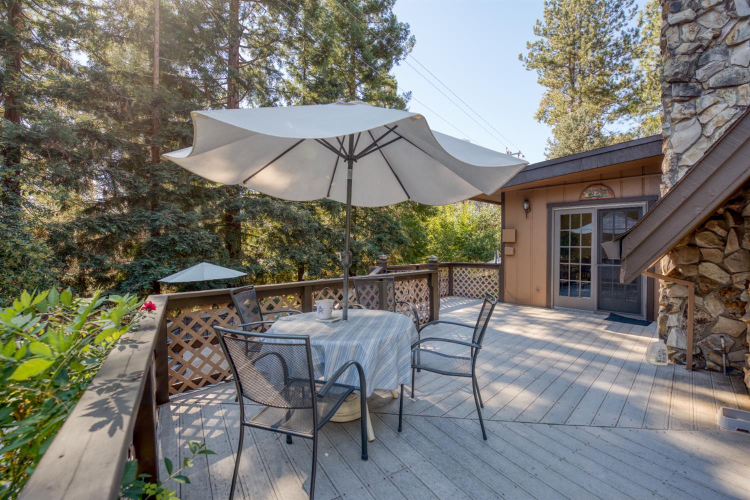 16979 Ridge Road Pine Grove, CA 95665 - Photo 27 of 68 a patio with wooden floor table and chairs