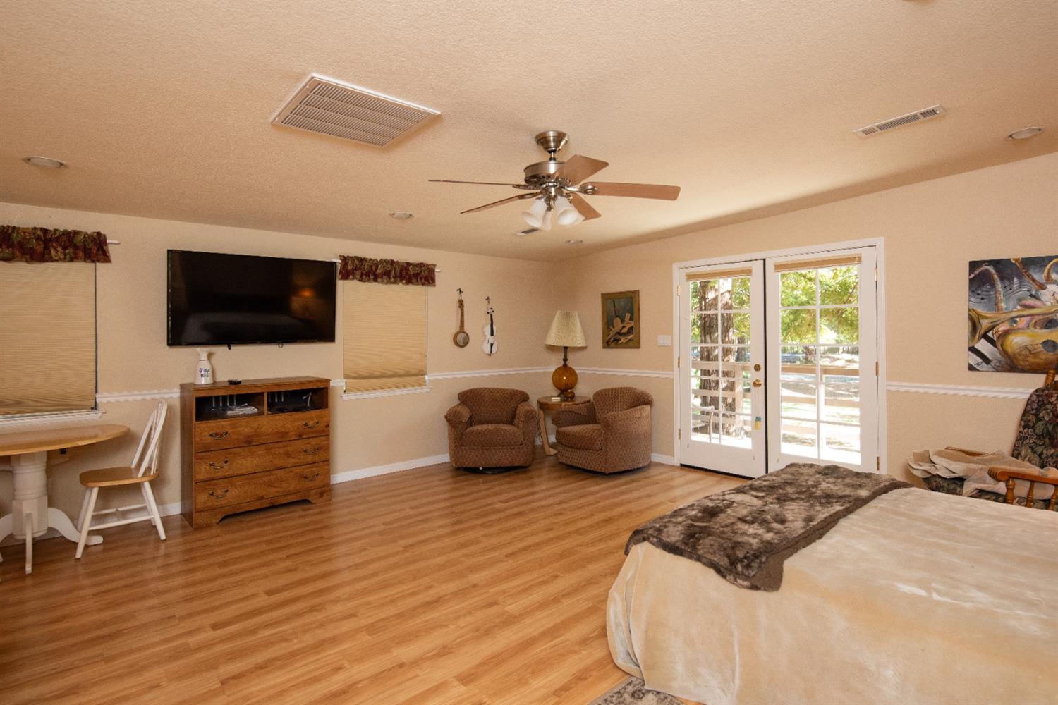 16979 Ridge Road Pine Grove, CA 95665 - Photo 35 of 68 a spacious bedroom with a bed and a flat screen tv
