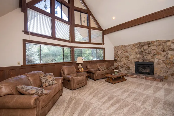 a living room with furniture large window and a fireplace