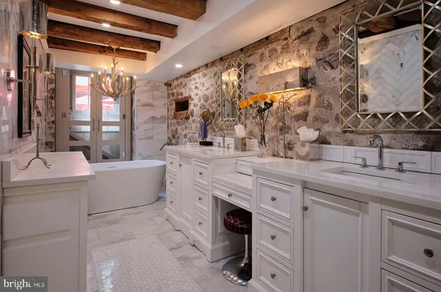 a spacious bathroom with a granite countertop sink mirror and bathtub