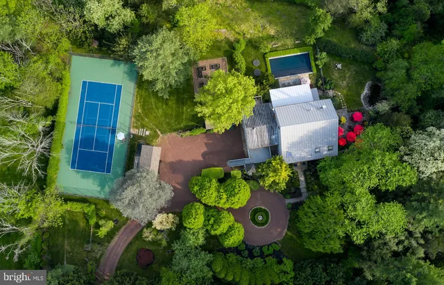 an aerial view of a house with a yard and garden