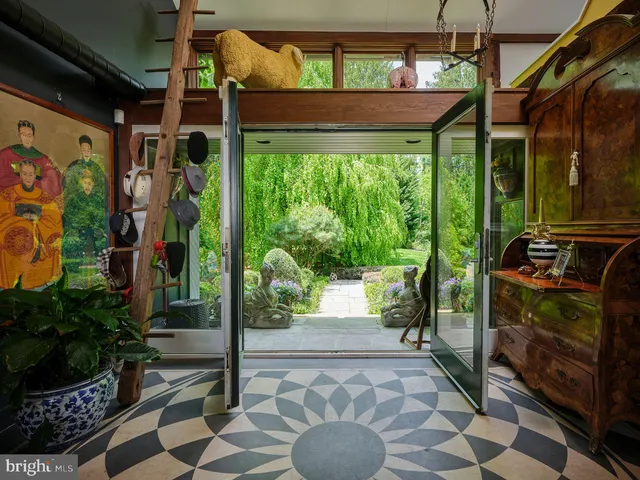 a view of a porch with furniture and garden