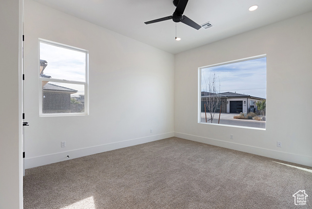 3145 Snow Cyn Road Hurricane, UT 84737 - Photo 11 of 38 Empty room featuring plenty of natural light, ceiling fan, light colored carpet, and recessed lighting