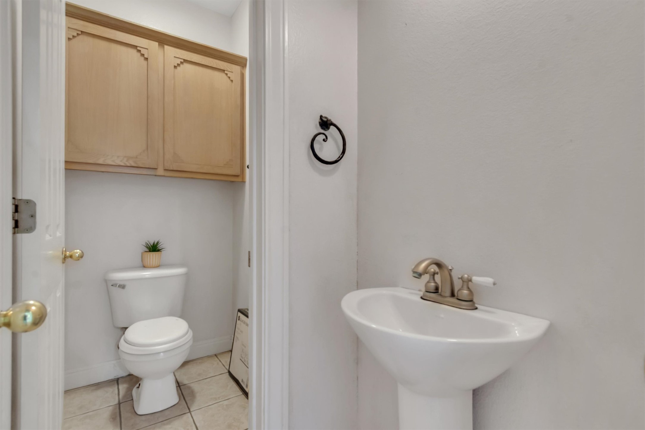 1120 Meadow Ridge Drive Austin, TX 78737 - Photo 9 of 40 A well-appointed powder room with classic fixtures and ample storage.