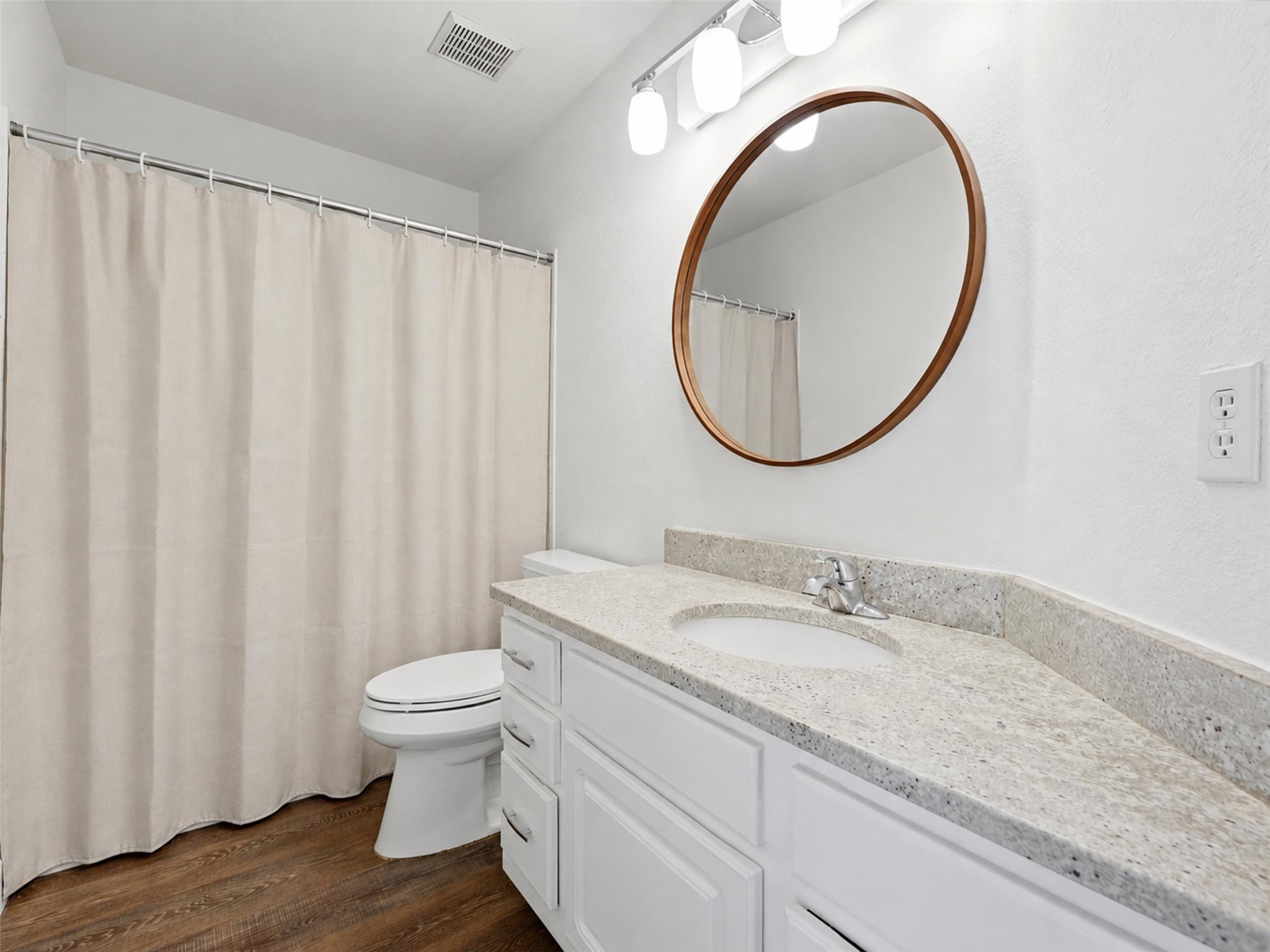 15207 Natural Spring Way Austin, TX 78728 - Photo 30 of 40 The full secondary bathroom comes with a granite topped vanity, stylish circular mirror and a shower/tub combo.