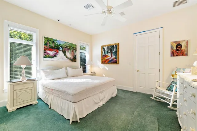 a bedroom with a bed dresser and a window