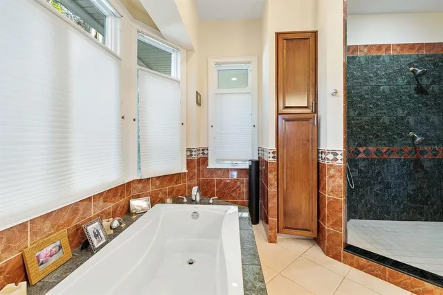 a bathroom with a tub and a shower