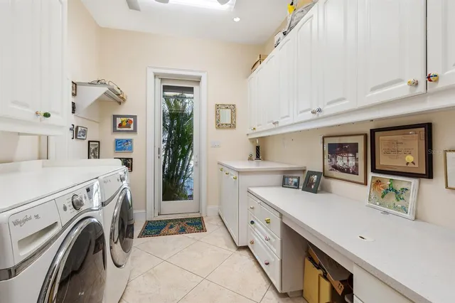 a view of washer and dryer with kitchen in the background