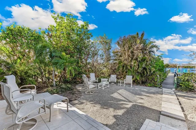 a view of a backyard with sitting area