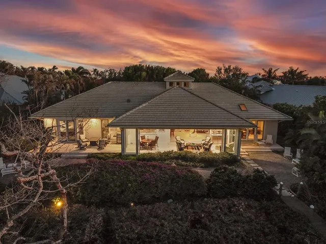 a backyard of a house with table and chairs