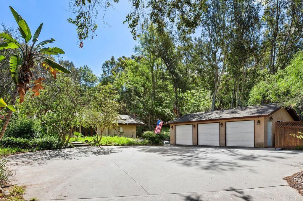 29560 Lilac Road Valley Center, CA 92082 - Photo 4 of 43 a front view of a house with a yard and a garage