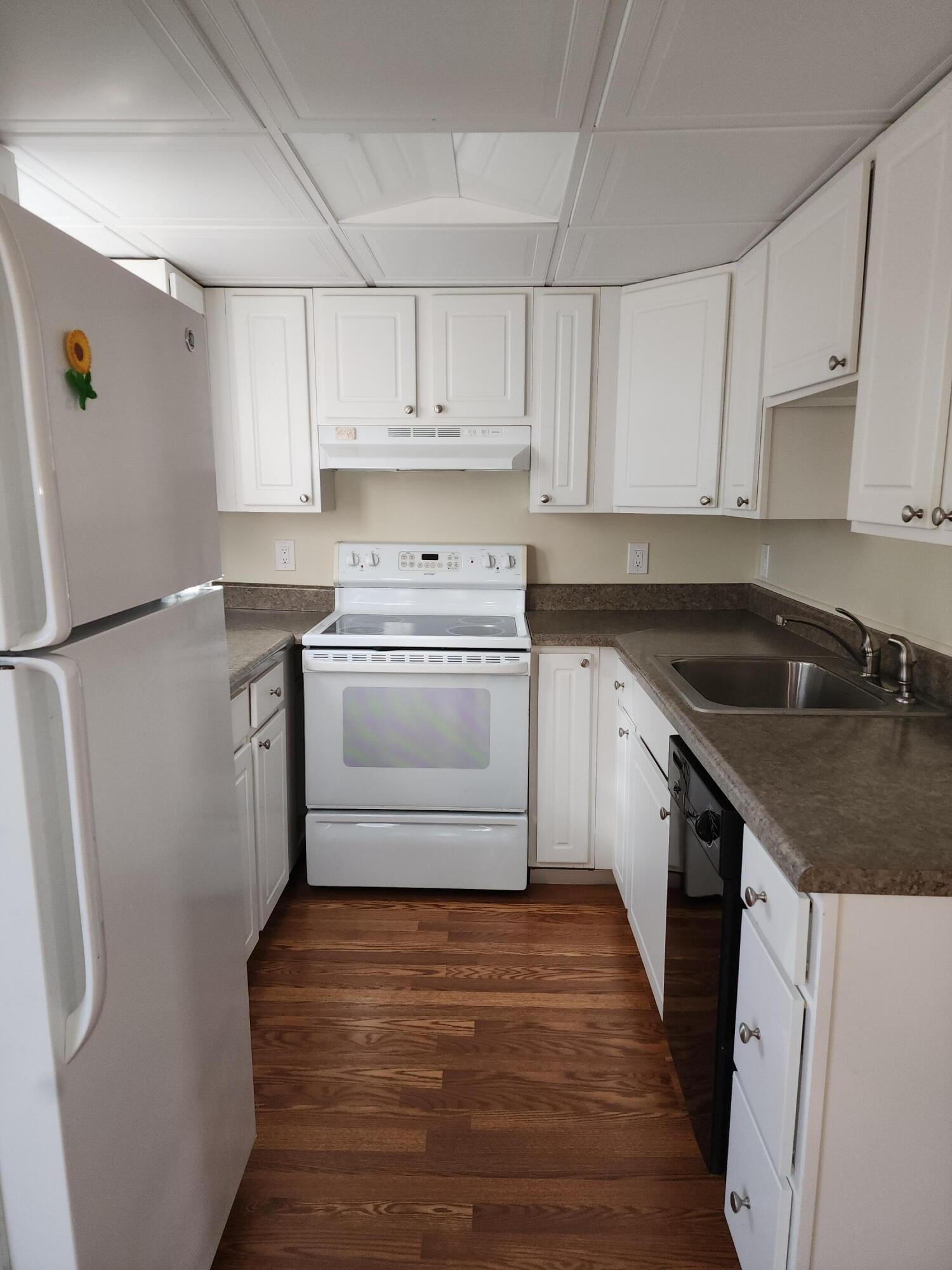 272 Craigville Beach Road, Unit 4 Hyannis, MA 02601 - Photo 11 of 33 a kitchen with a sink stove and refrigerator