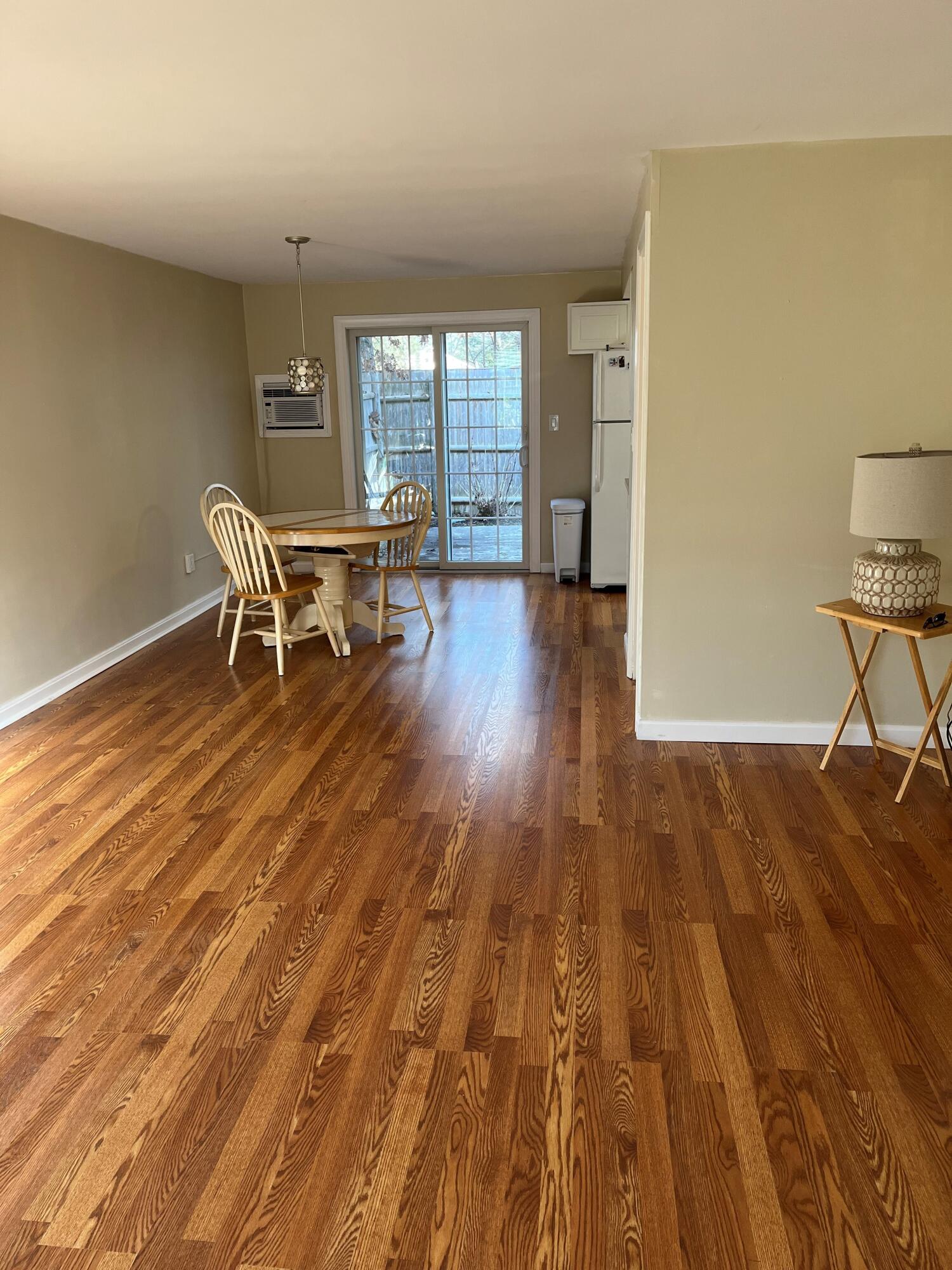 272 Craigville Beach Road, Unit 4 Hyannis, MA 02601 - Photo 14 of 33 a view of a room with wooden floor chairs and windows