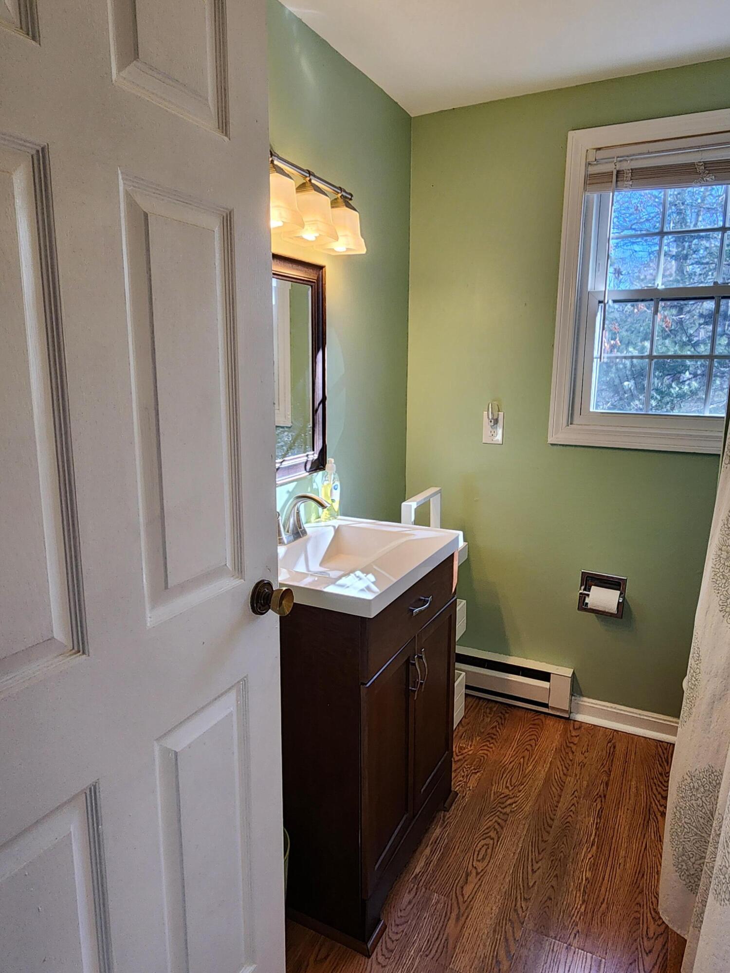 272 Craigville Beach Road, Unit 4 Hyannis, MA 02601 - Photo 16 of 33 a view of a bathroom with a sink and mirror