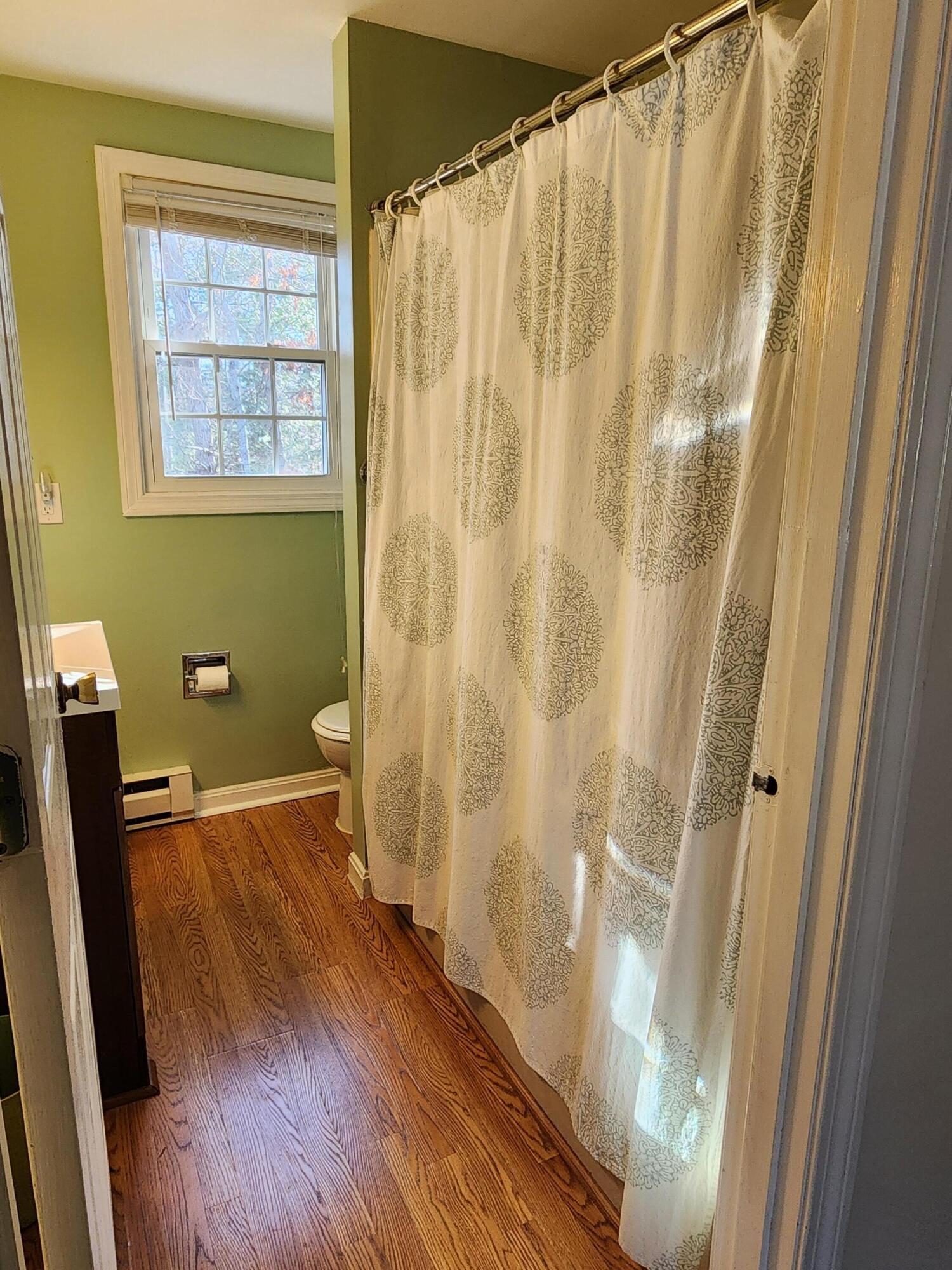 272 Craigville Beach Road, Unit 4 Hyannis, MA 02601 - Photo 17 of 33 a view of a bathroom with wooden floor and a sink
