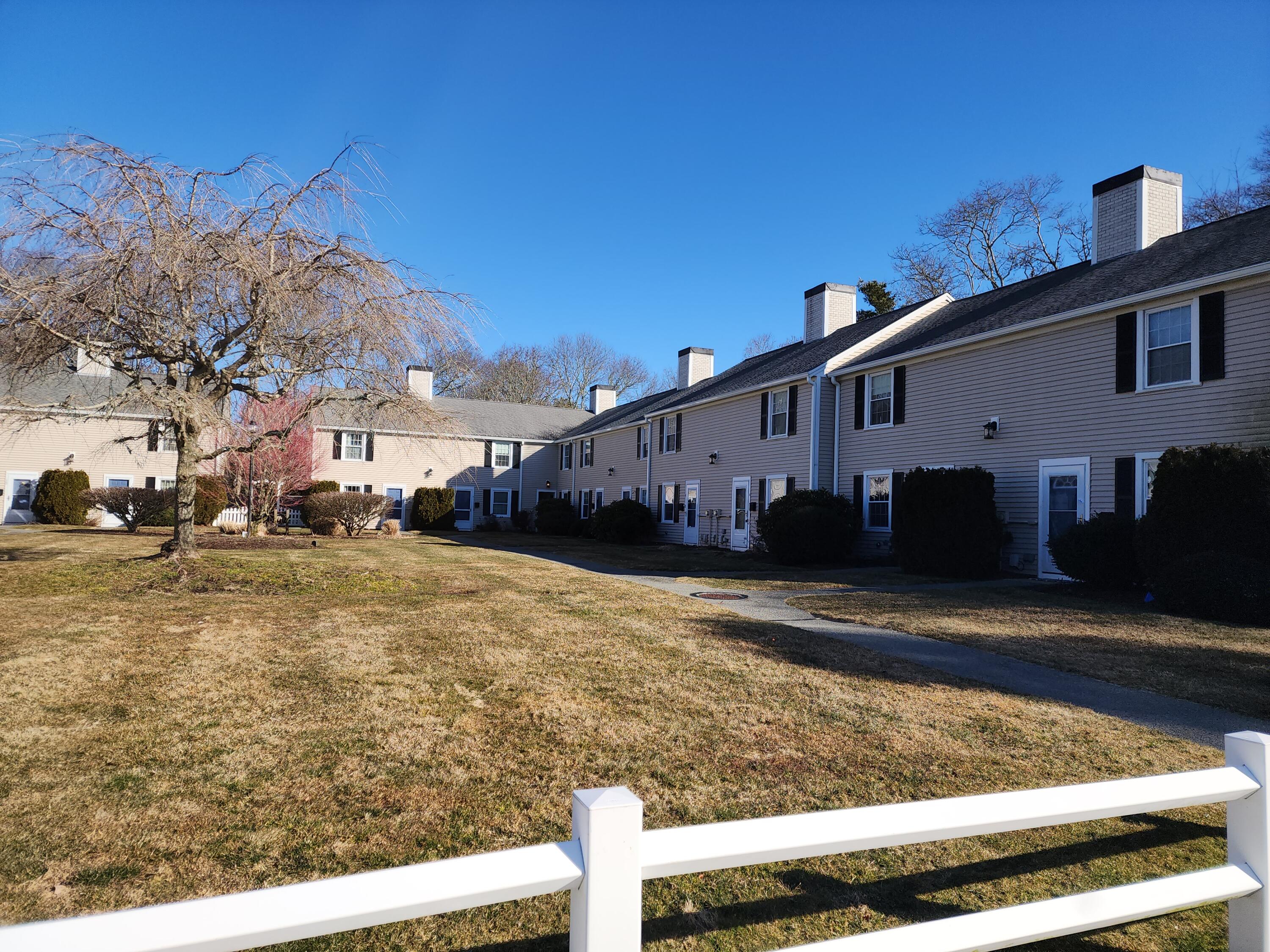 272 Craigville Beach Road, Unit 4 Hyannis, MA 02601 - Photo 2 of 33 a view of a house with backyard and trees