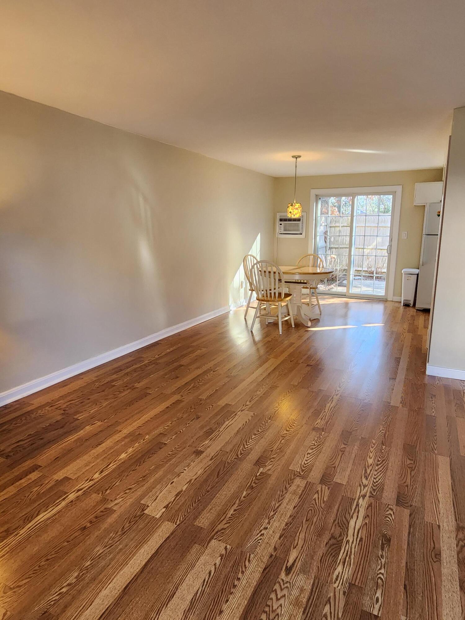 272 Craigville Beach Road, Unit 4 Hyannis, MA 02601 - Photo 8 of 33 a view of dining room with wooden floor and floor to ceiling window