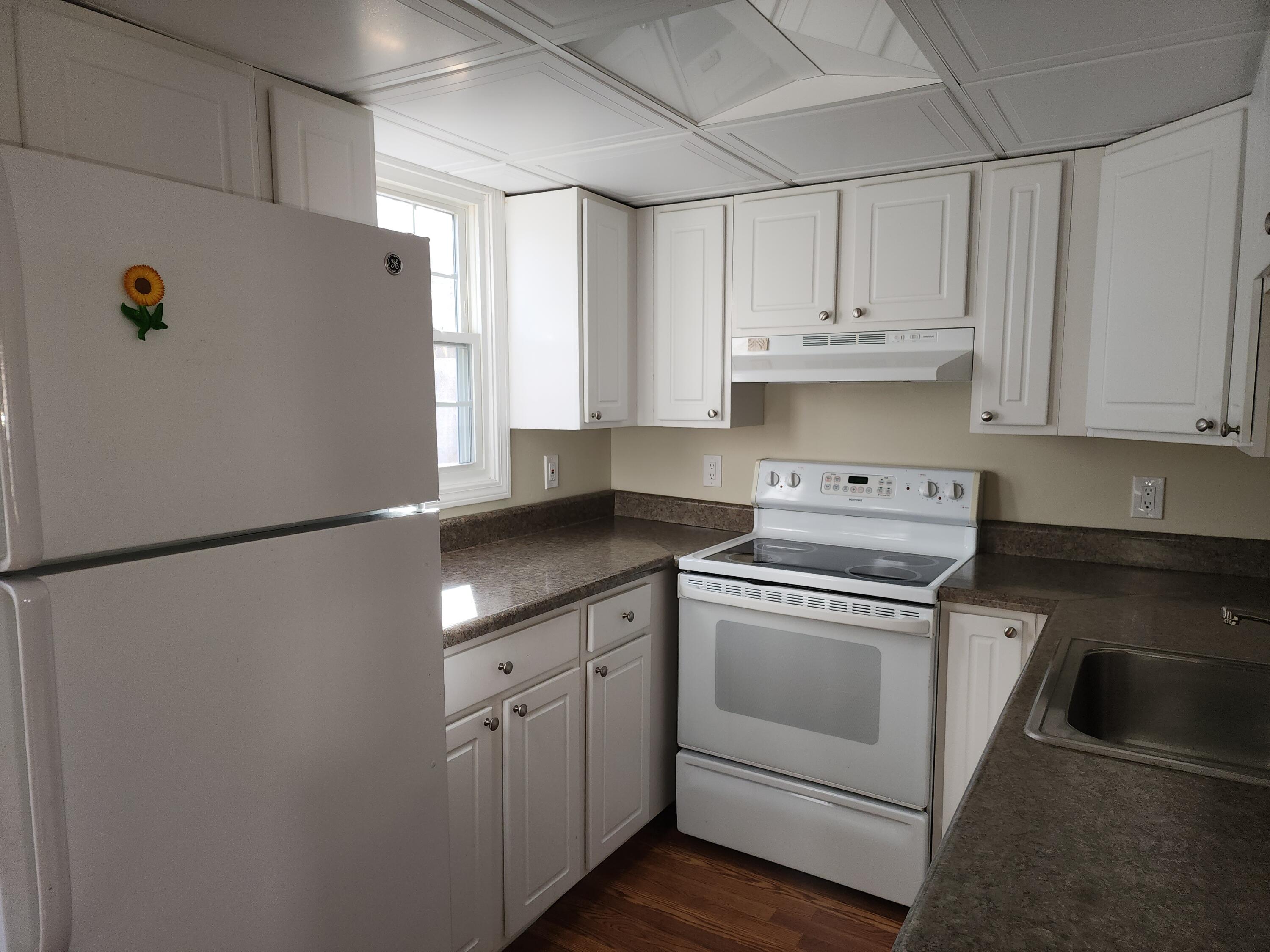 272 Craigville Beach Road, Unit 4 Hyannis, MA 02601 - Photo 10 of 33 a white refrigerator freezer sitting inside of a kitchen