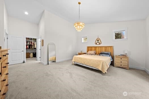 10218 45th Street East Edgewood, WA 98372 - Photo 17 of 34 a bedroom with a bed and a window