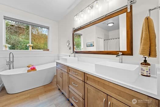 10218 45th Street East Edgewood, WA 98372 - Photo 18 of 34 a bathroom with a tub sink and a large mirror