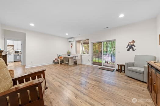 10218 45th Street East Edgewood, WA 98372 - Photo 20 of 34 a large living room with stainless steel appliances granite countertop a couch and a view of living room
